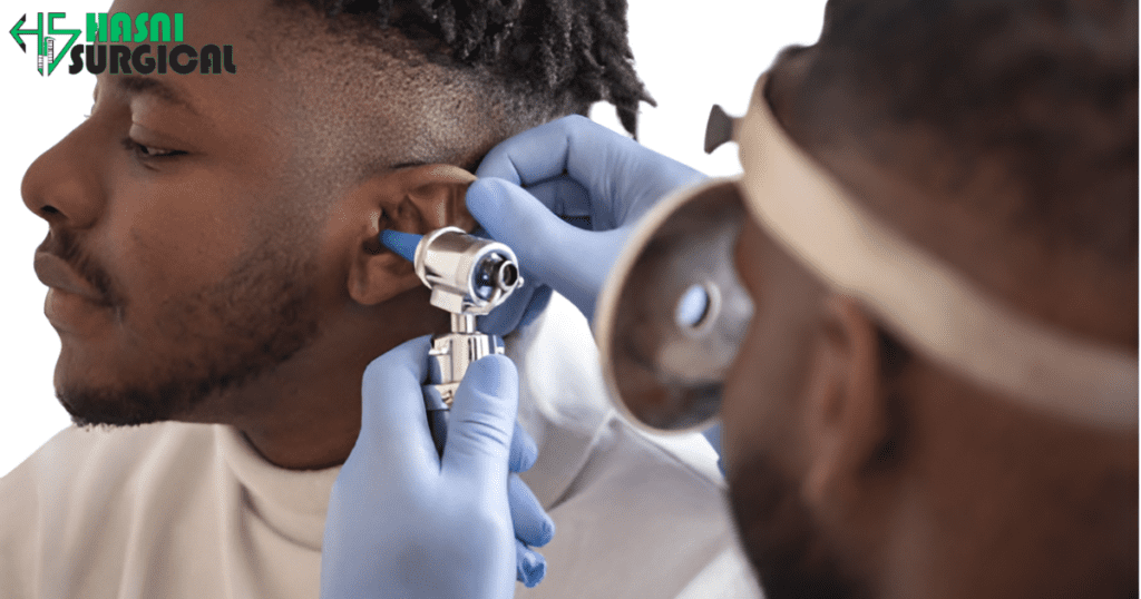 A doctor checks the ear of a patient with an ENT instrument.