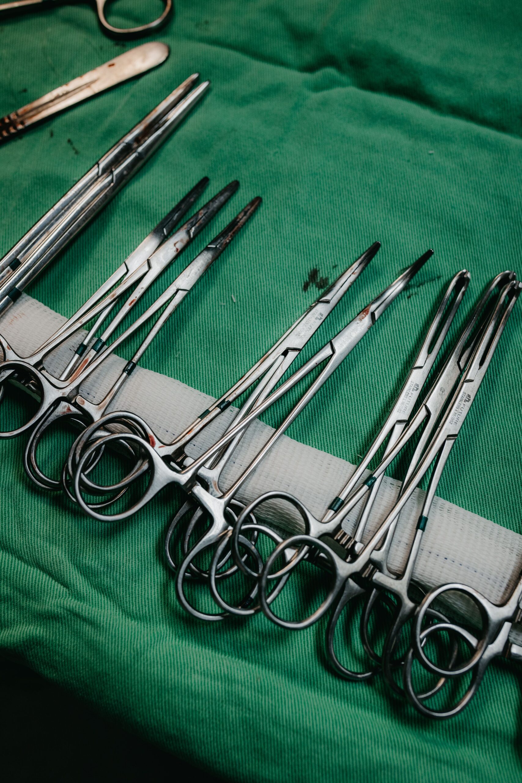 Surgical thinning scissors on sterile green cloth - Hasni Surgical Pakistan manufacturer