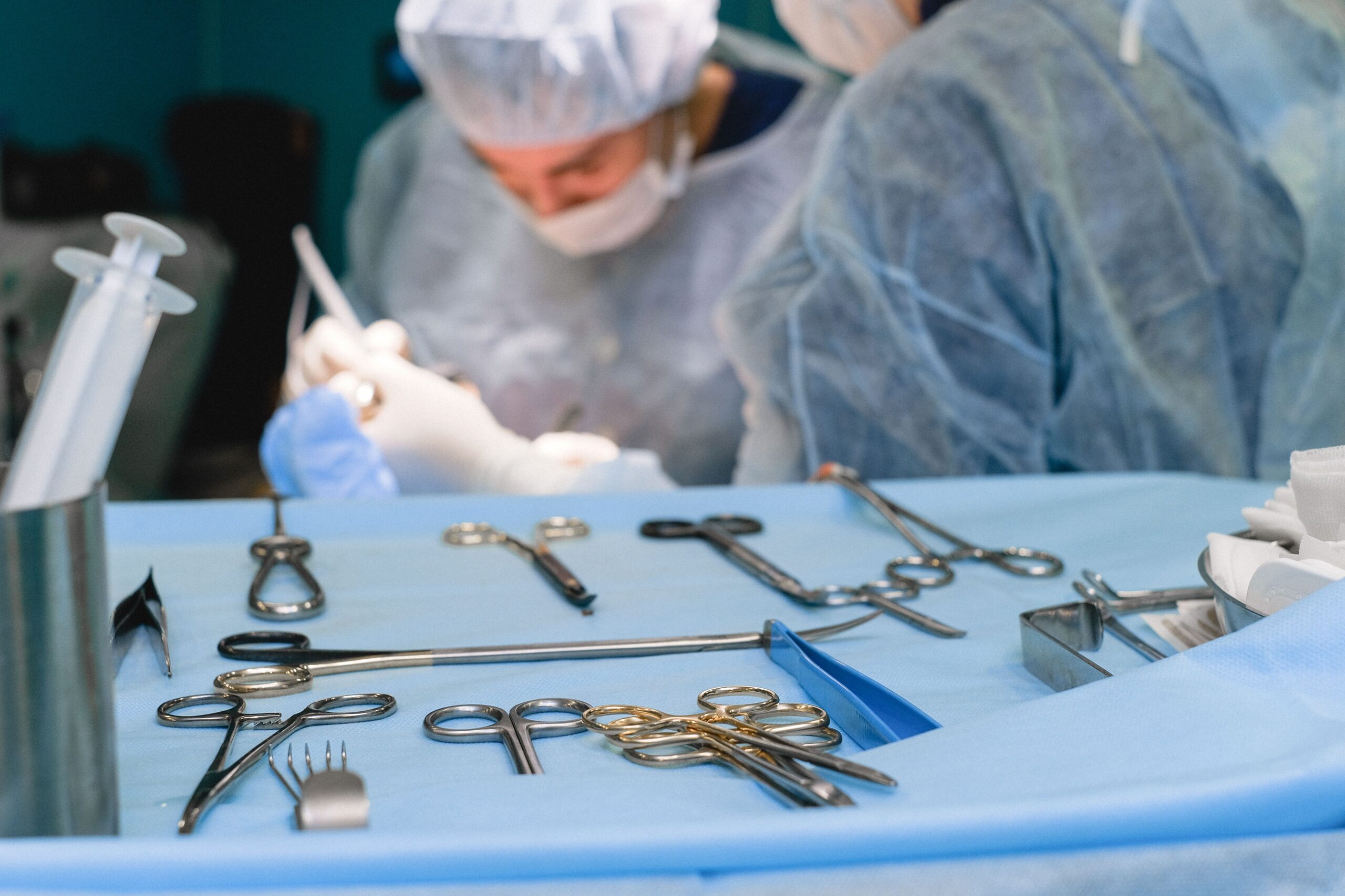 Medical surgical instruments including scalpel forceps retractors and needle holder arranged on sterile tray during surgery