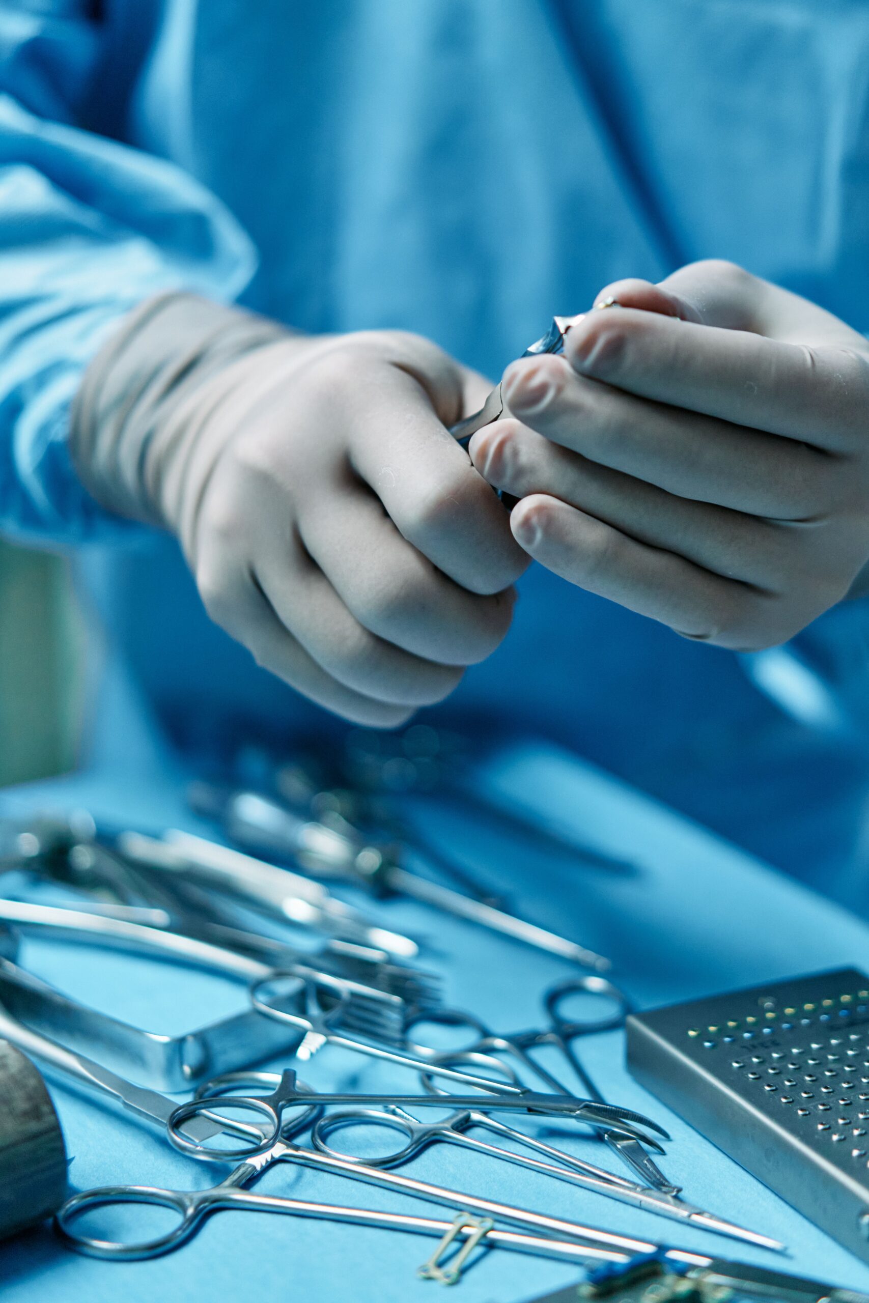 Surgeon hands holding precision surgical scissors in operating room