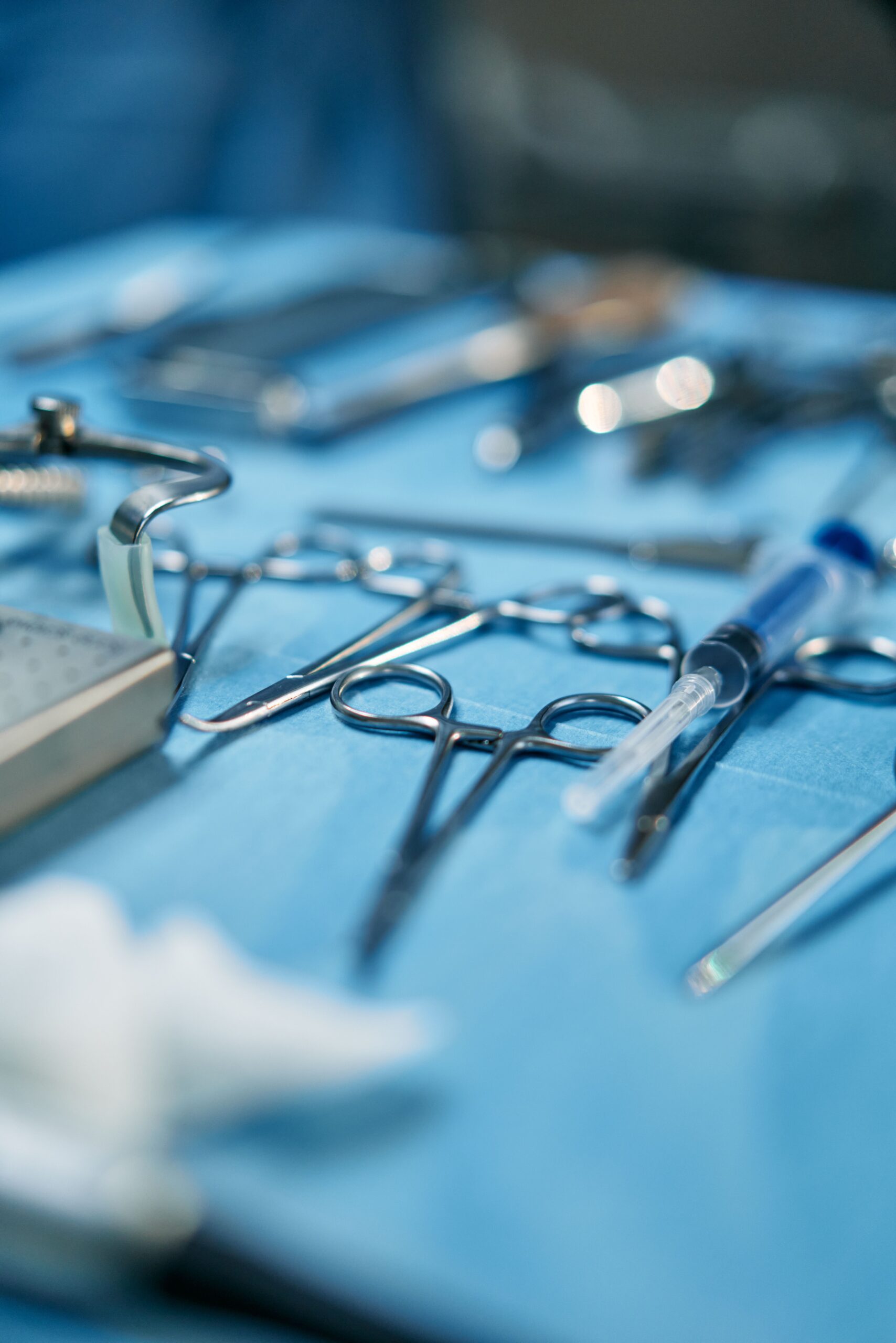 Orthopedic surgical instruments arranged on sterile blue drape in operating room
